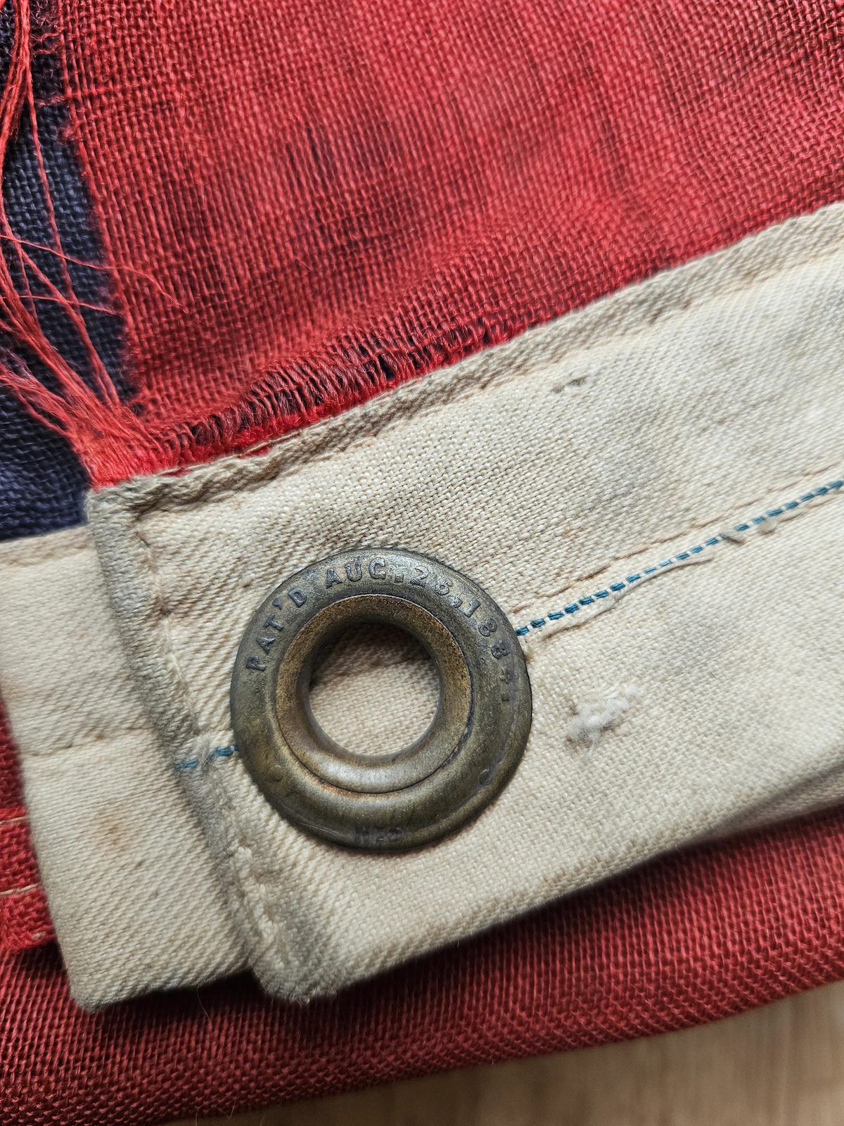 Close-up of brass grommet marked PAT’D AUG 28 1884