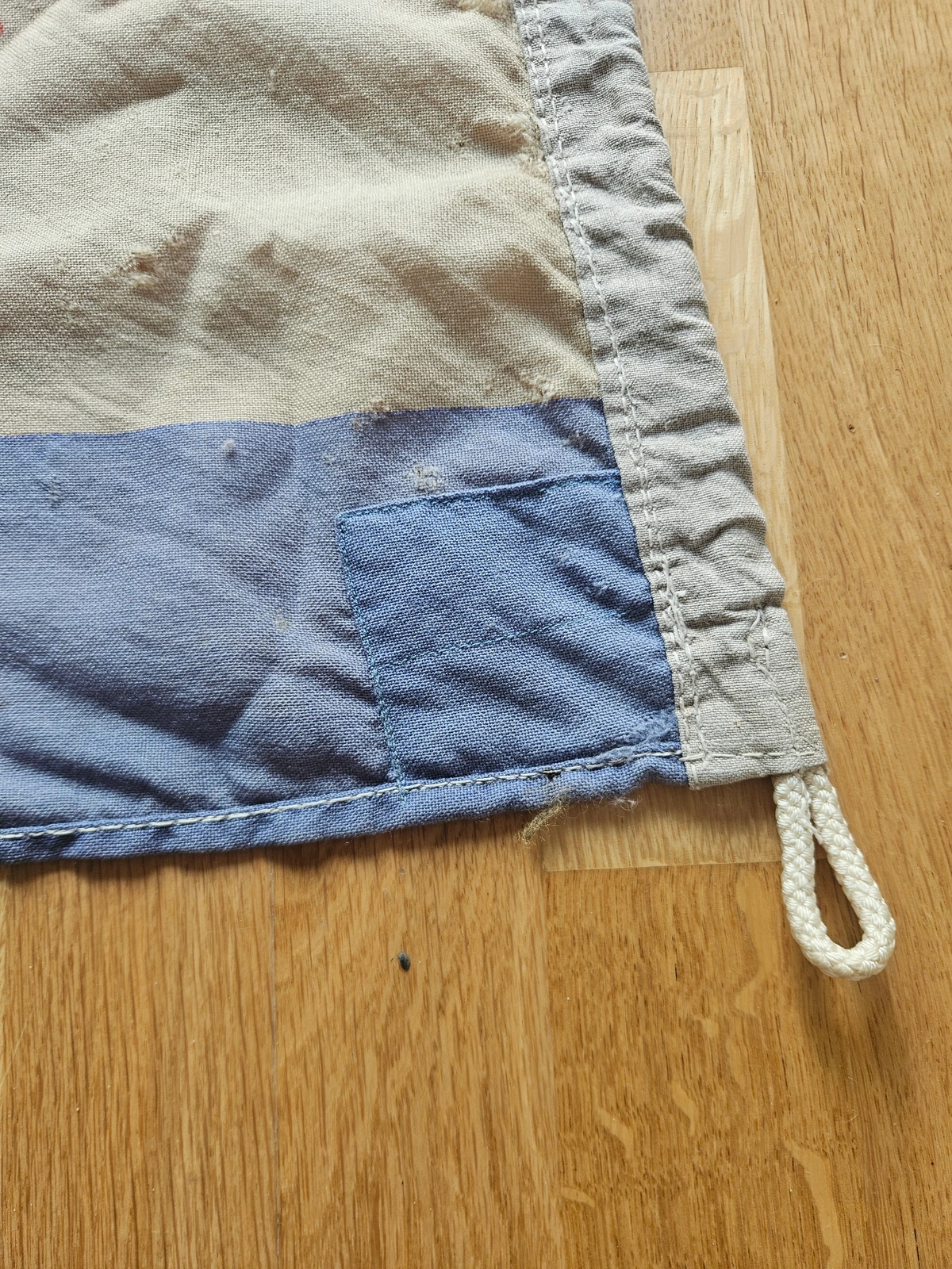 Lower fly corner with blue repair patch and triangular reinforcement rows