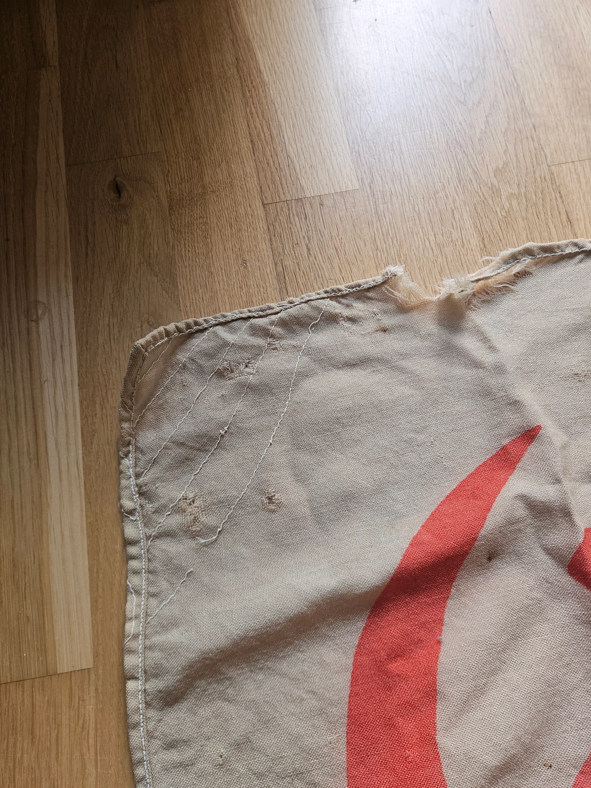 Top edge wear and stitch layout near the star