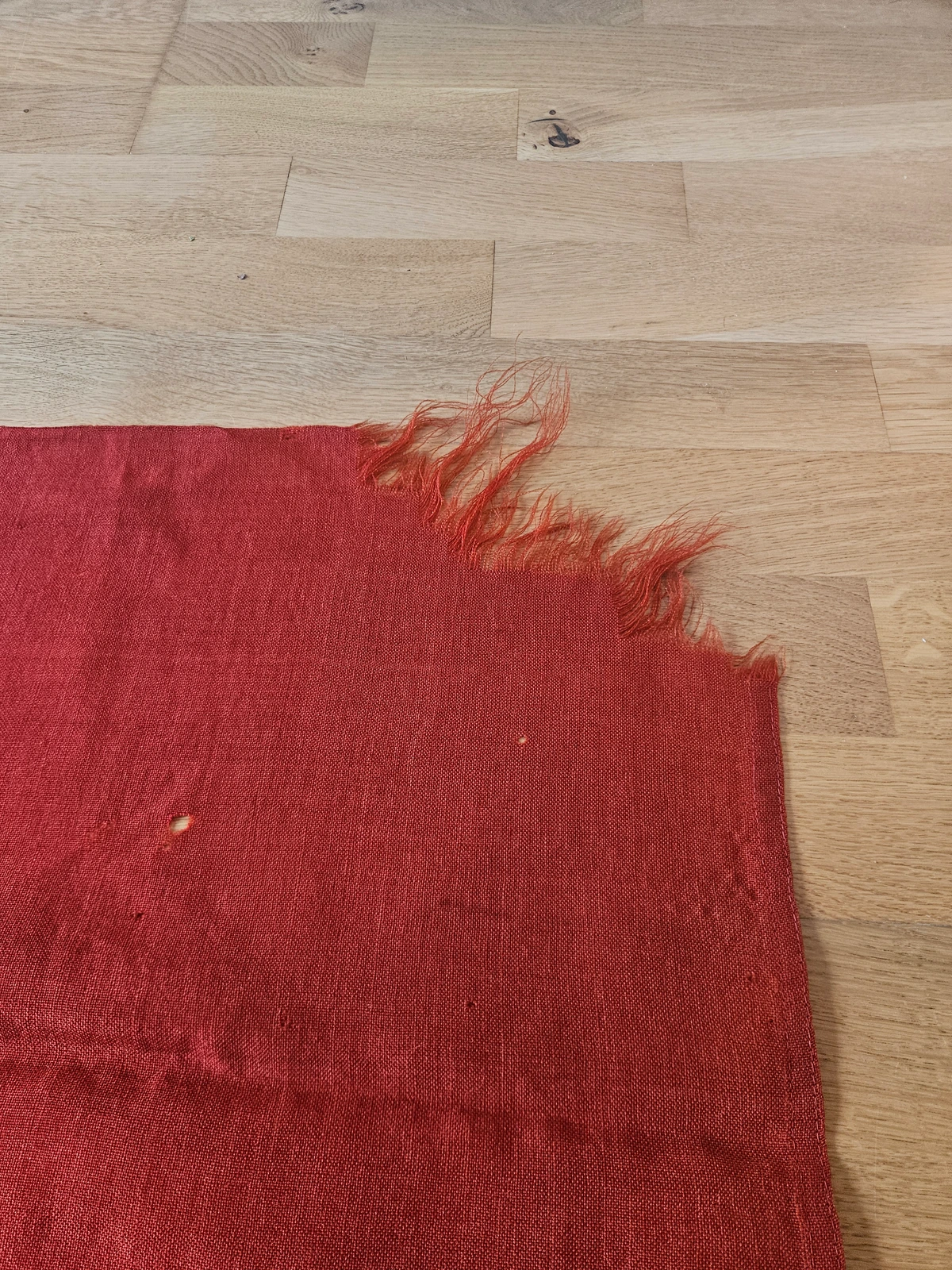 Fly-end wear — fray and small moth losses consistent with period use.