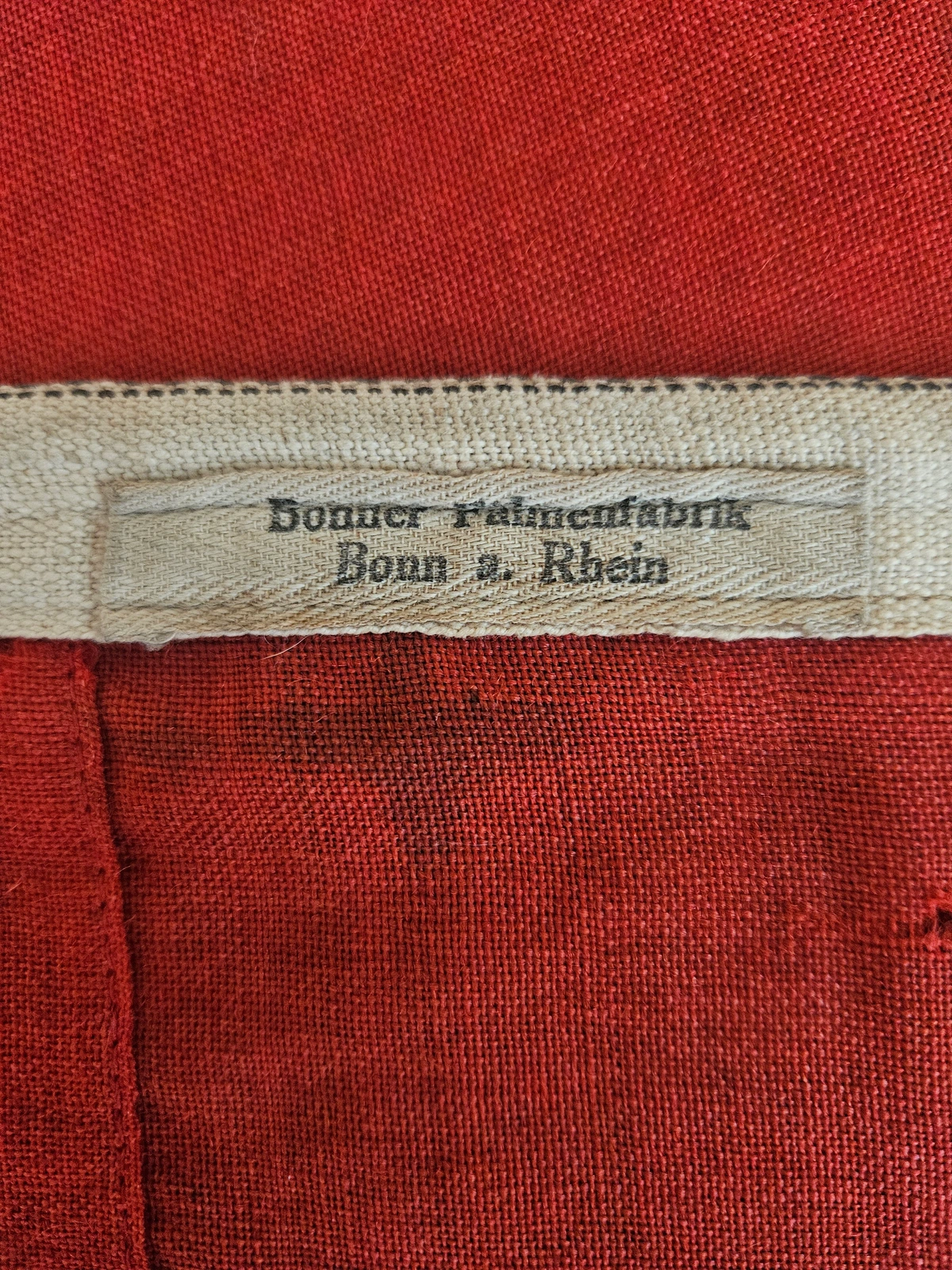 Maker label — Bonner Fahnenfabrik, Bonn a. Rhein (woven hoist tag).