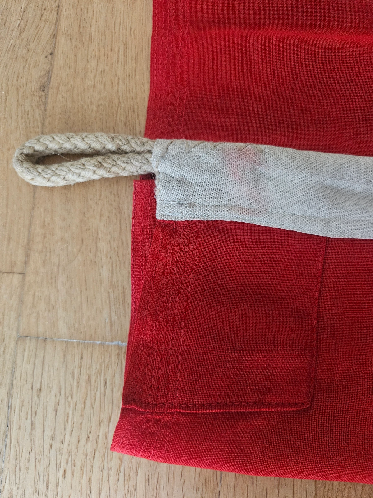 Hoist detail — rope lanyard with spliced eye; heavy canvas heading.