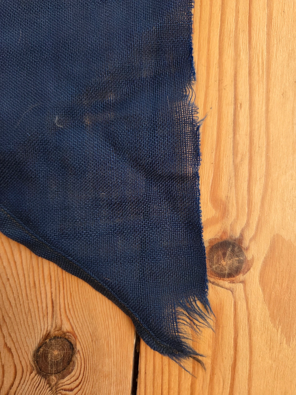 Frayed swallowtail edge on wool bunting, showing fatigue and black lockstitch
