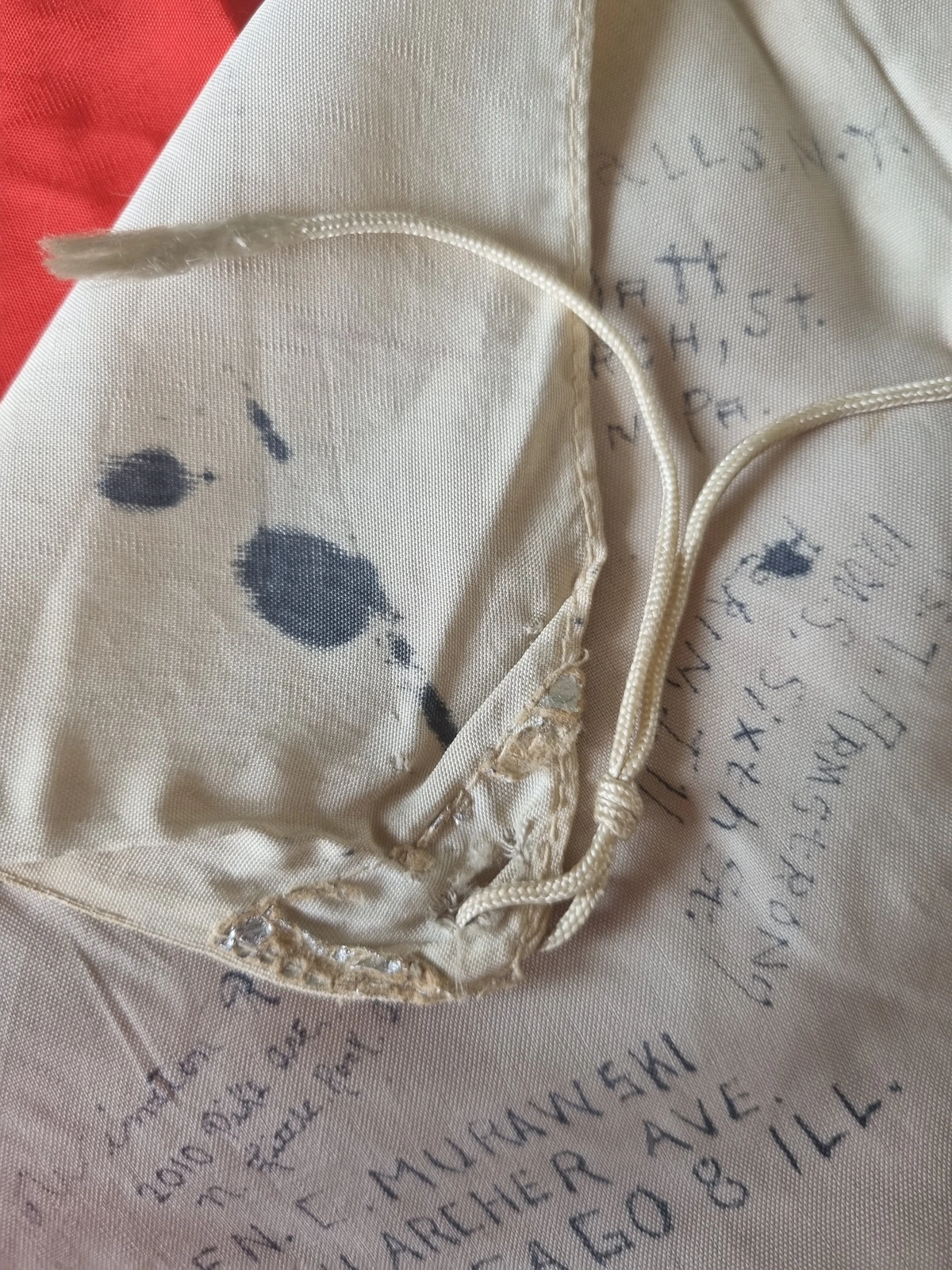 Printed disc texture and feathered pen strokes across silk surface