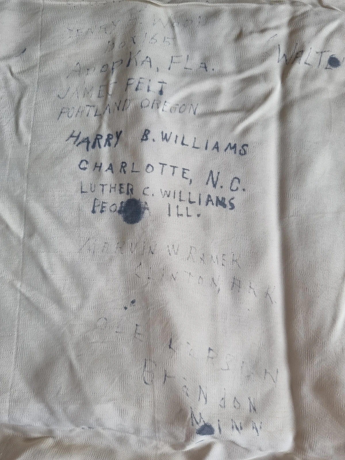 Edge wear on silk; printed disc edge visible; ink feathering around GI signature strokes