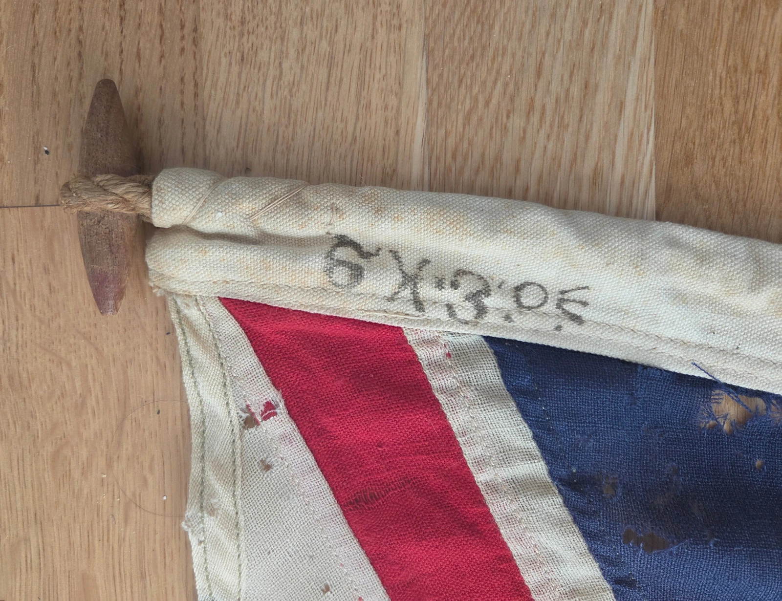 Hoist header with 3×6 stencil, admiral crow foot and wooden toggle fitted to hemp rope