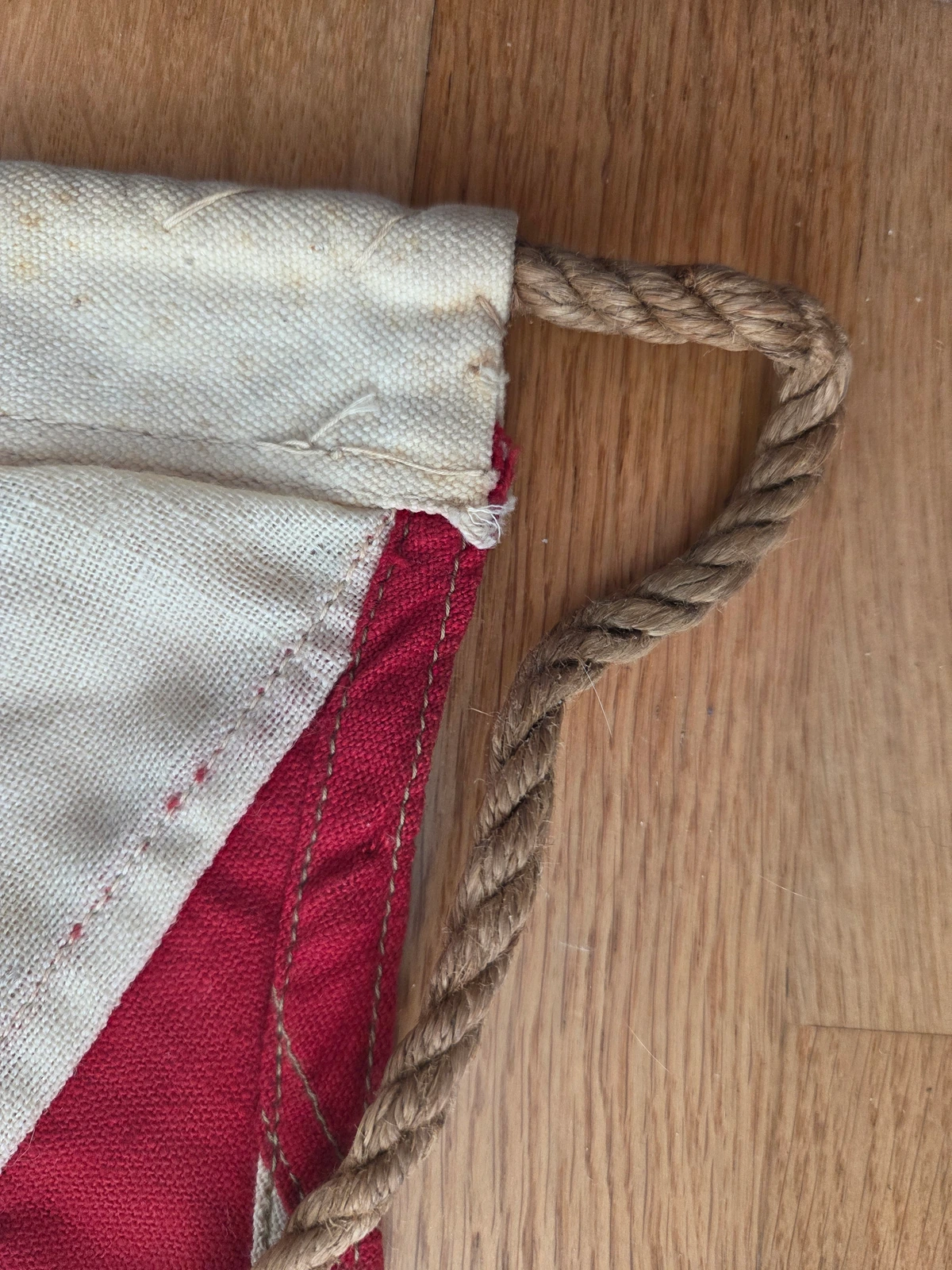 Hoist end: rope exiting header sleeve, whip-stitch termination