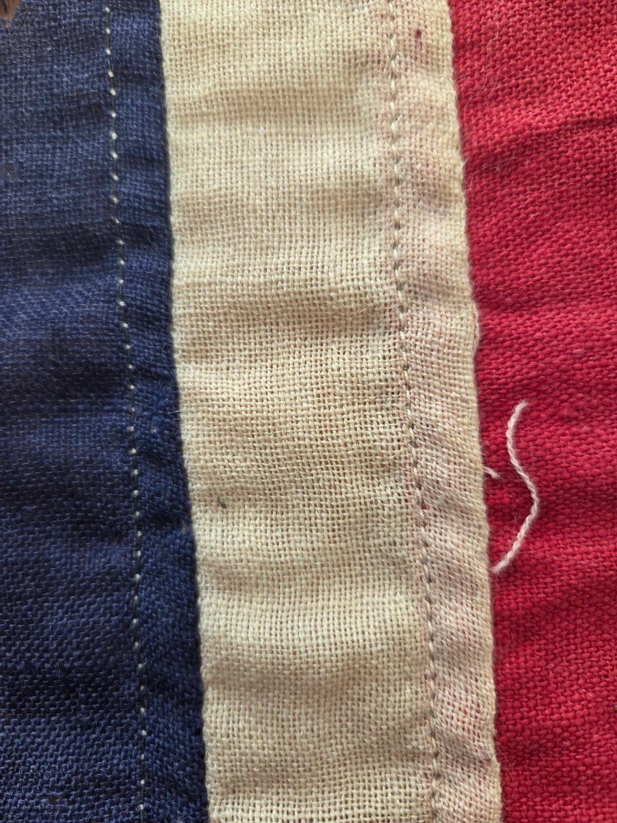 White stripe seam: straight lockstitch, no zig-zag reinforcement