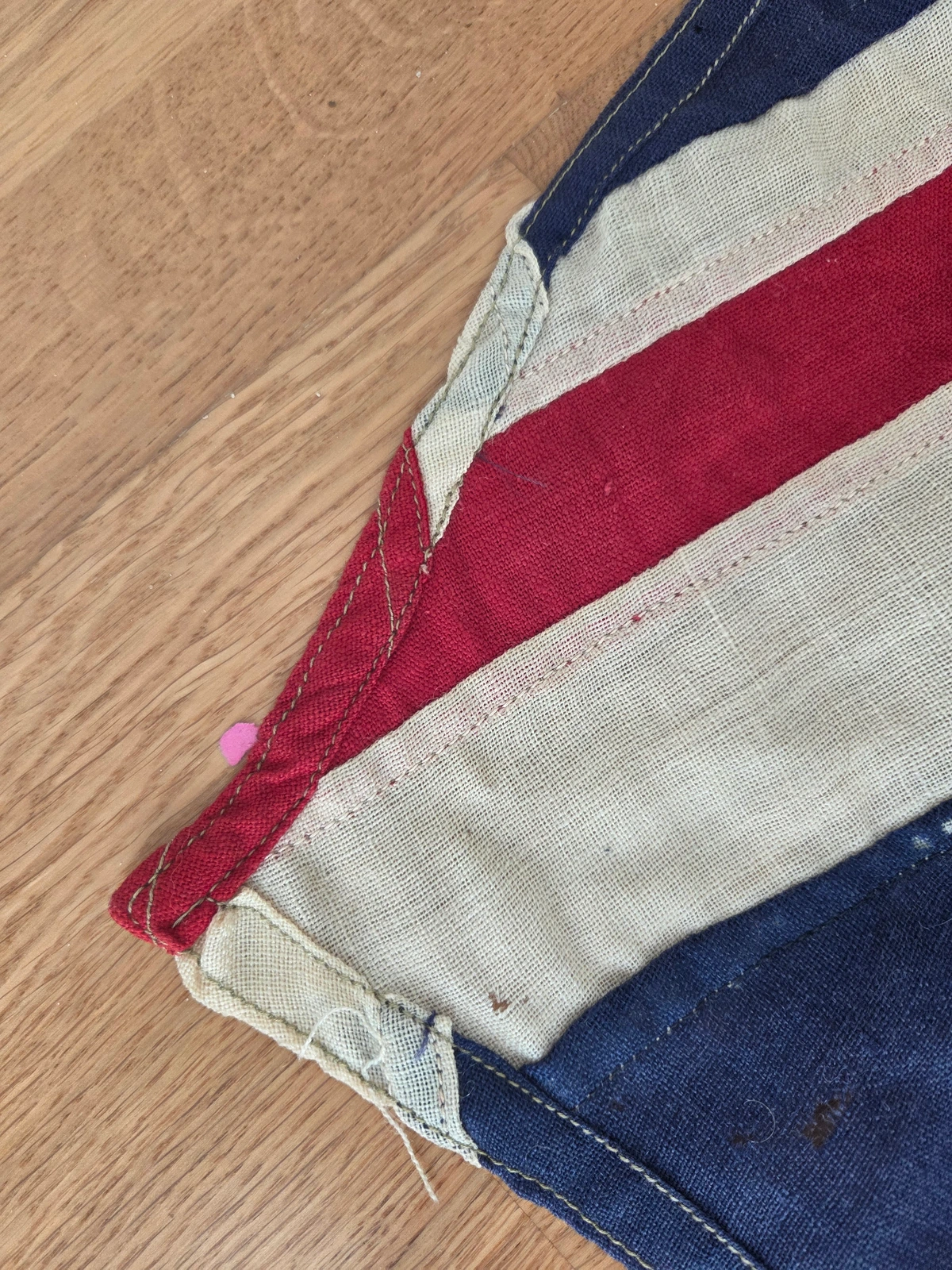 Fly corner reinforcement with folded tabs and multiple stitch rows