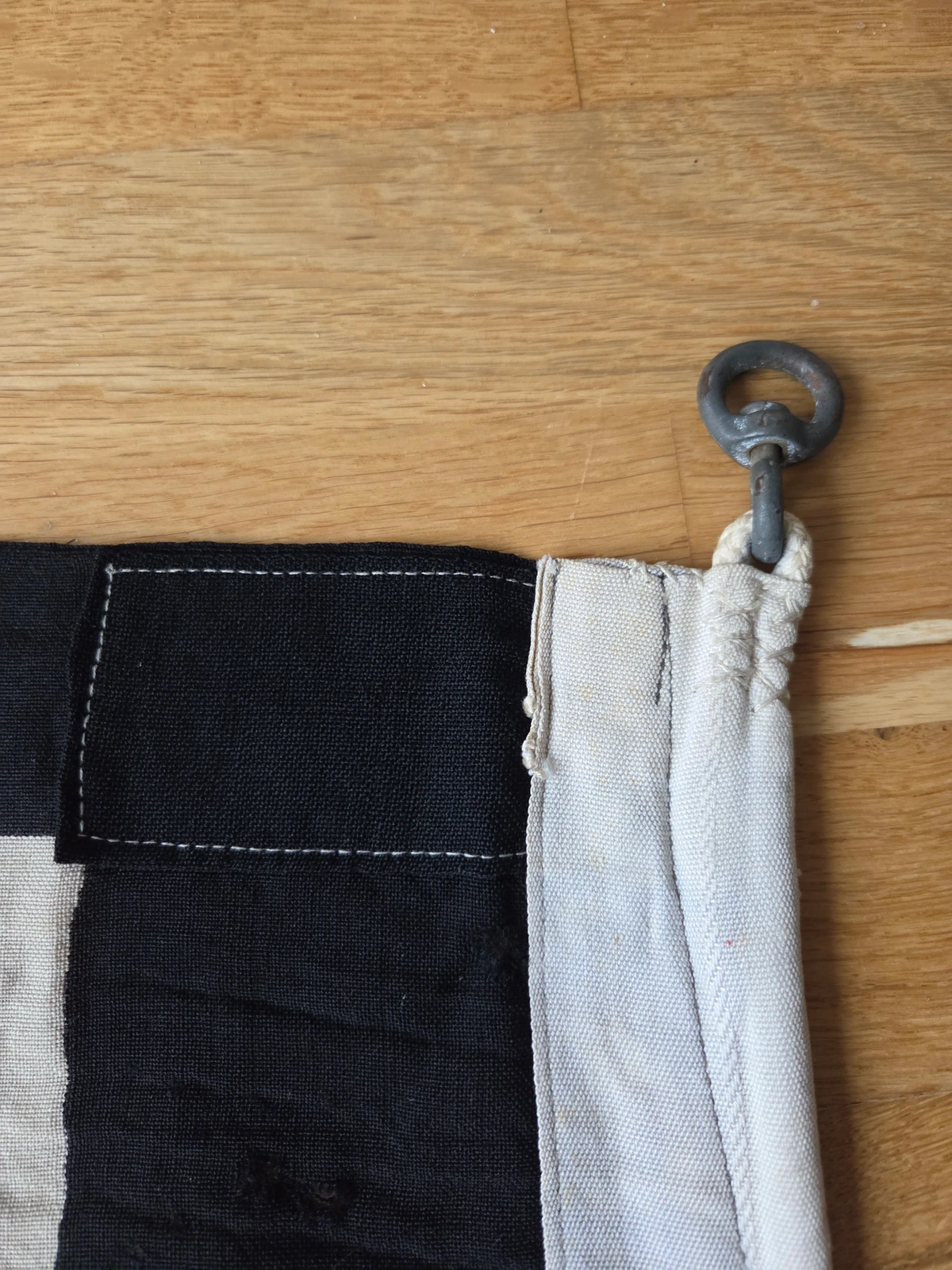 Hoist corner with reinforced stitching and metal swivel ring
