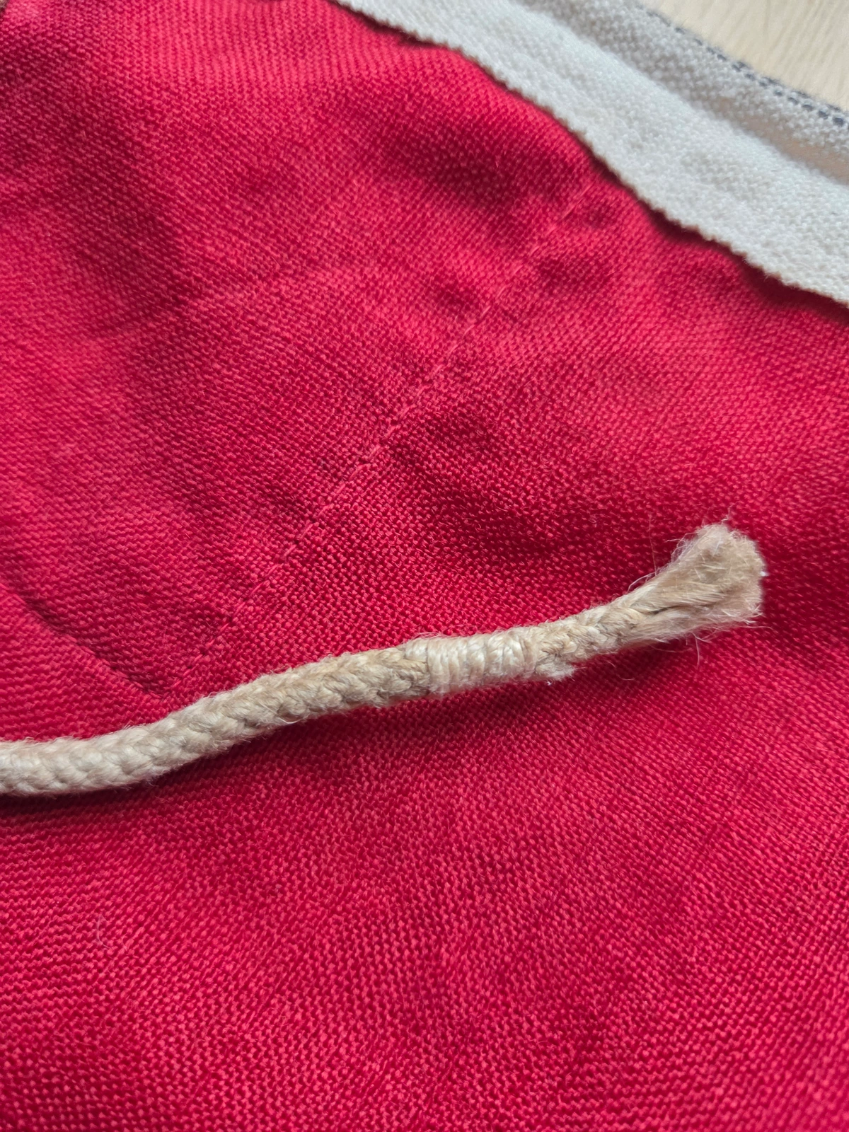 End of the hoist rope, frayed and twisted, typical of period naval rigging.