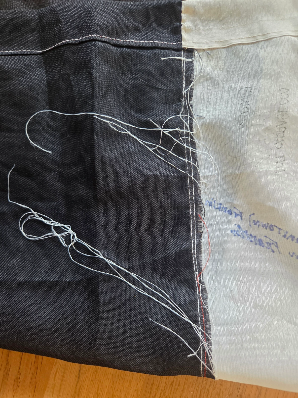 Loose threads and rough stitching visible on the reverse of FG-061