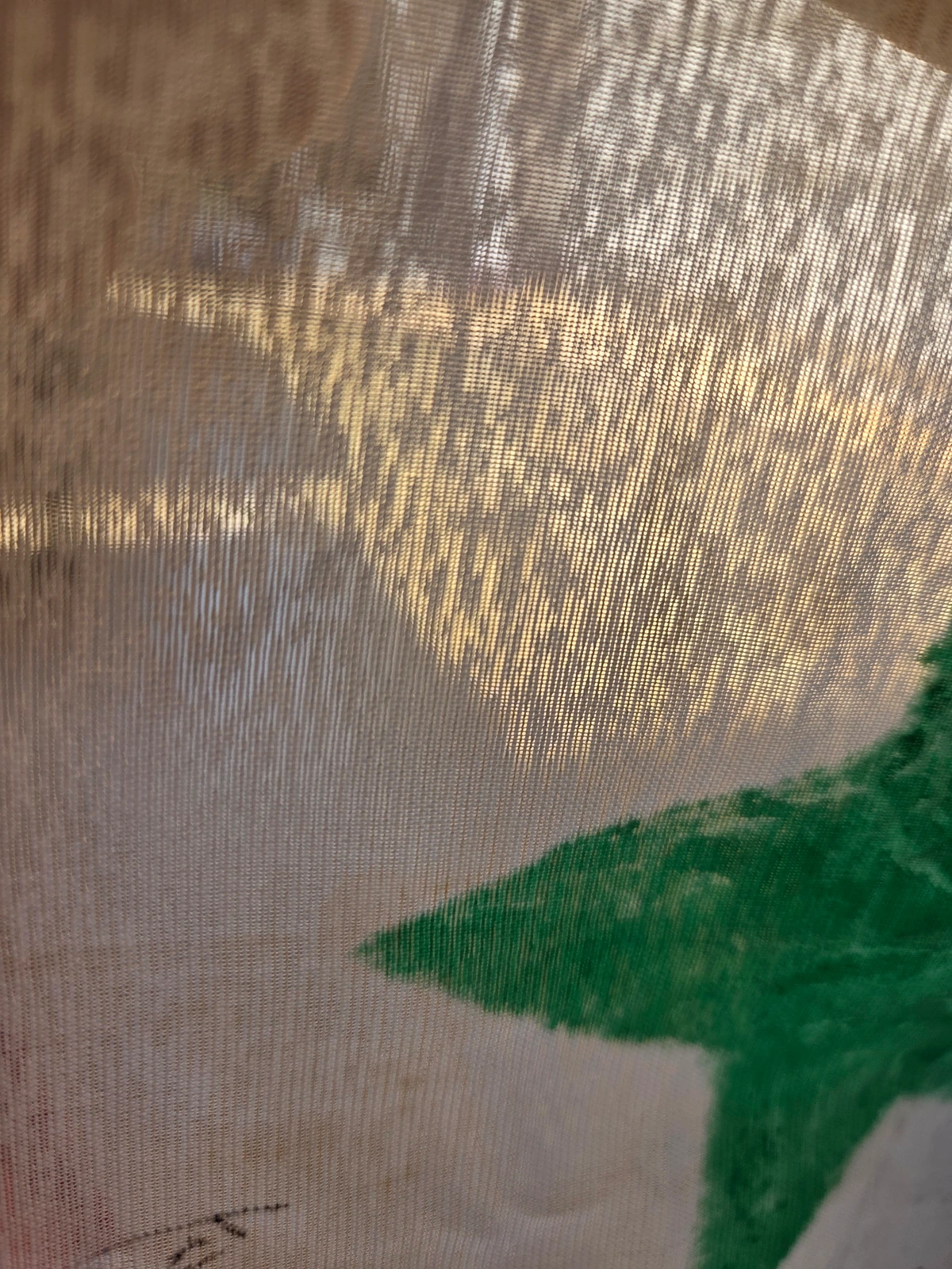 Light passing through the thin synthetic fabric of FG-061