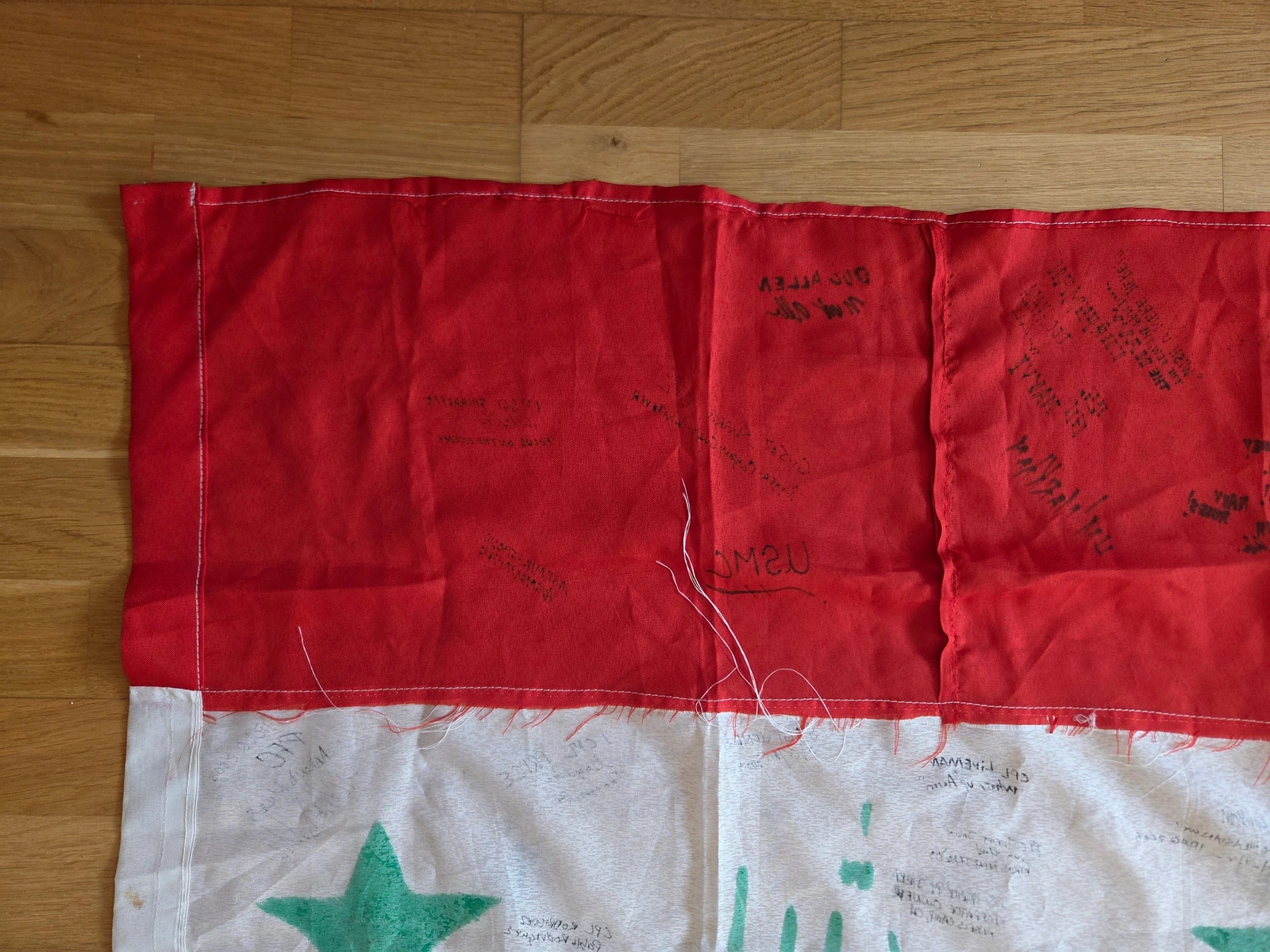 Loose threads and irregular seam construction in the repaired red section of FG-061