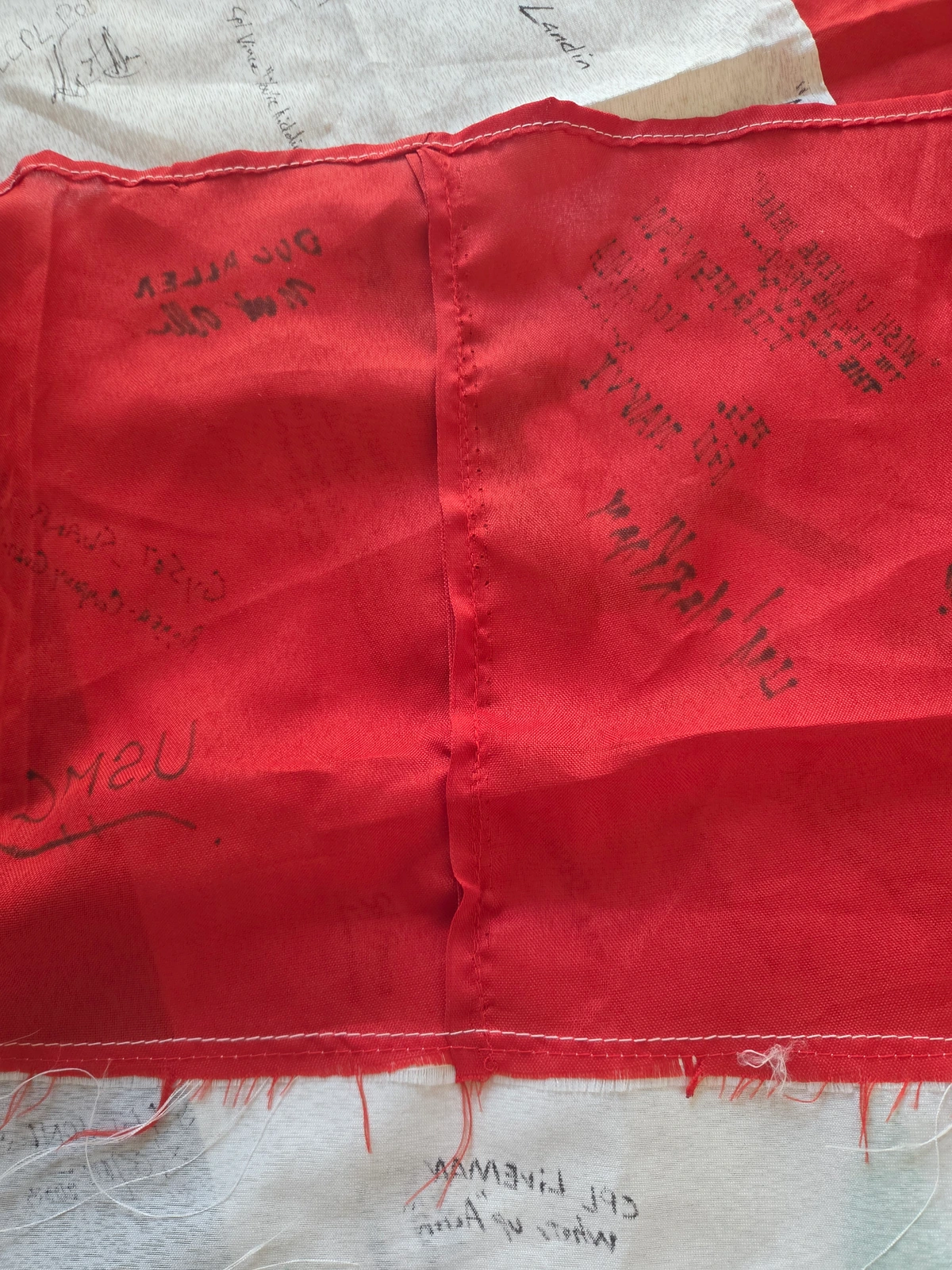 Re-sewn section of the red field on the reverse of FG-061