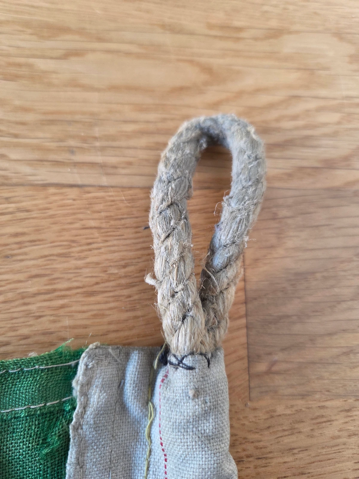 Upper rope loop secured with black hand stitching on FG-063