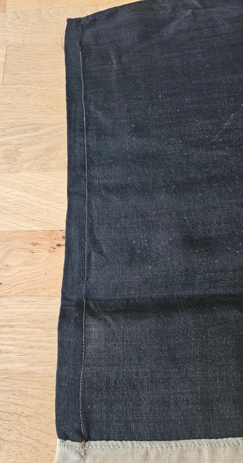Top fly corner with folded hem and straight machine seam
