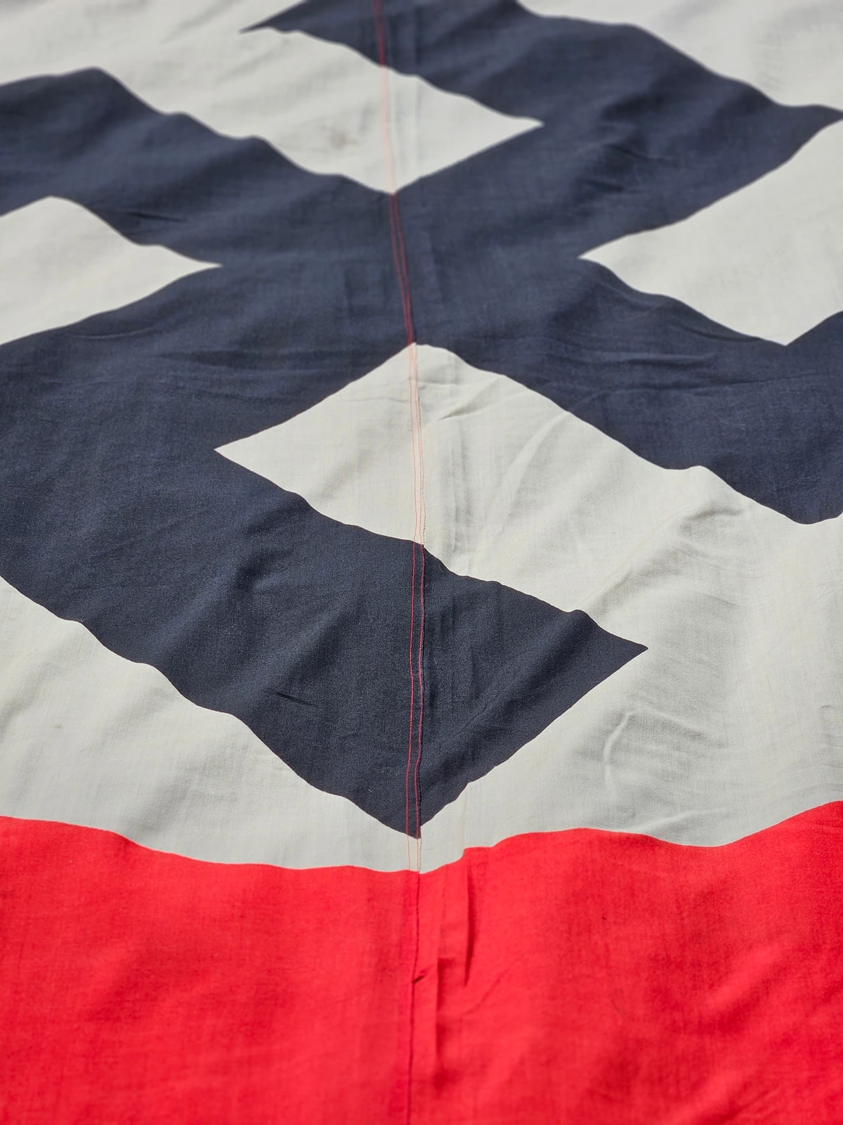 The roundel is printed across two vertical fabric panels, joined by a central seam. This construction method was typical for oversize flags.