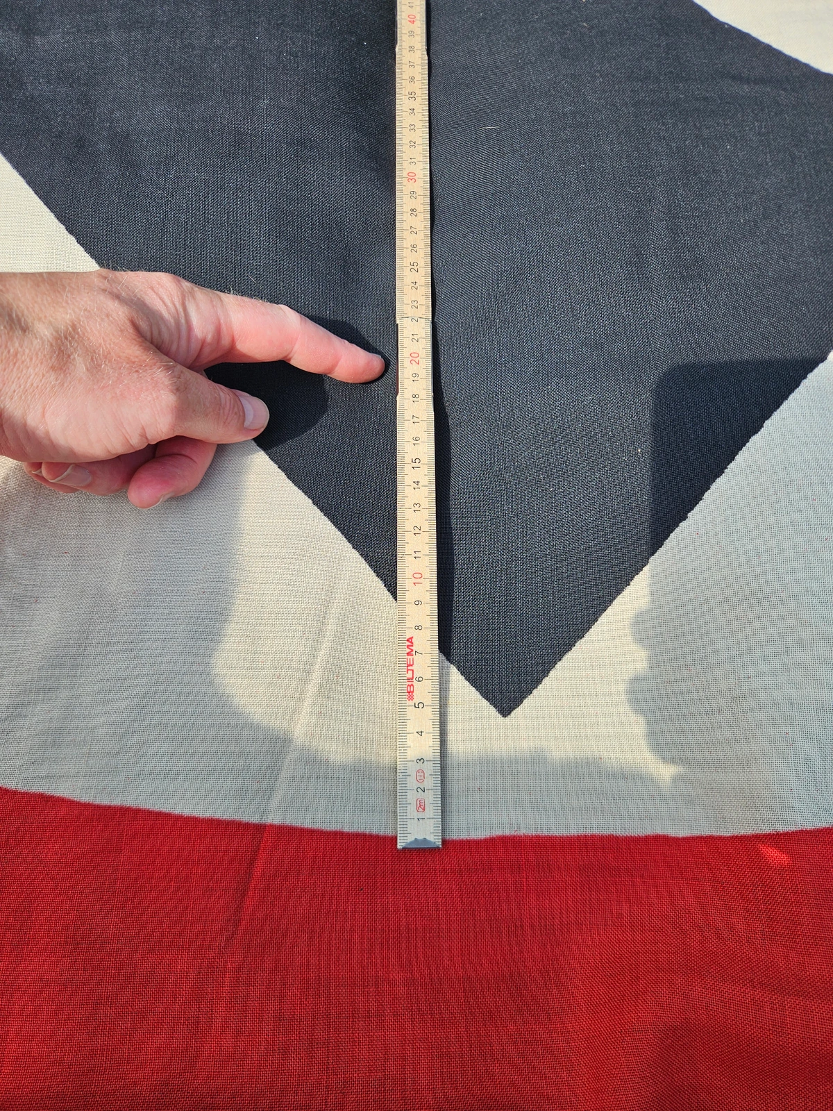 Close-up of the printed swastika and white field, with size reference. Print quality and textile grain are clearly visible.