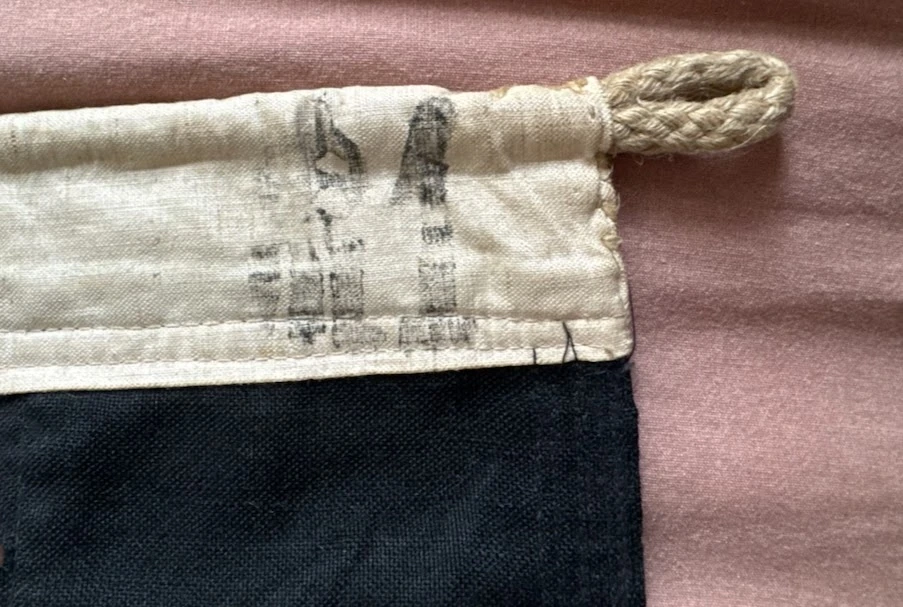 Faded secondary stamp near the hoist rope loop