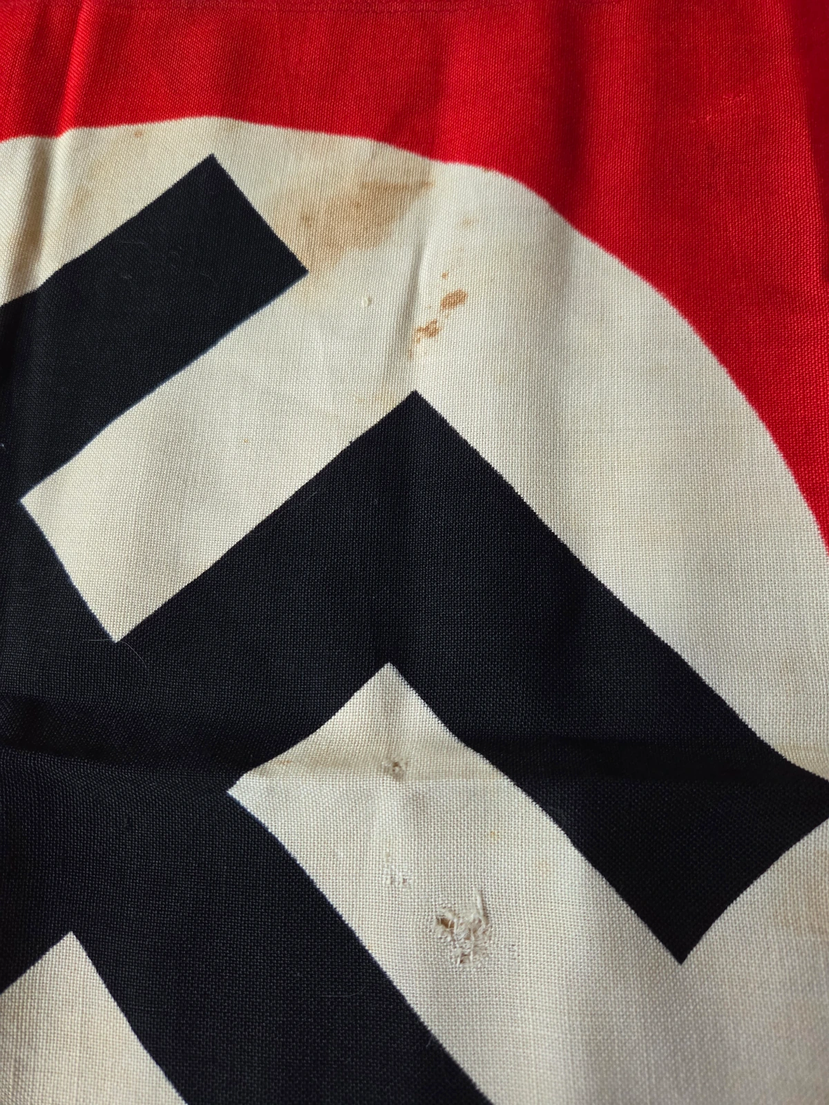 Storage wear — small hole in field and localized smudge
