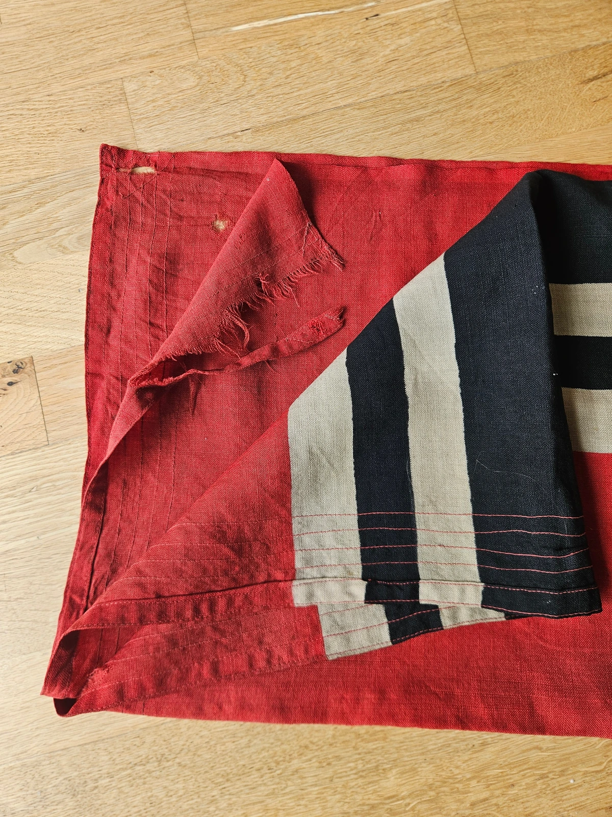 Fly end with wind damage and reinforced 6-needle stitching