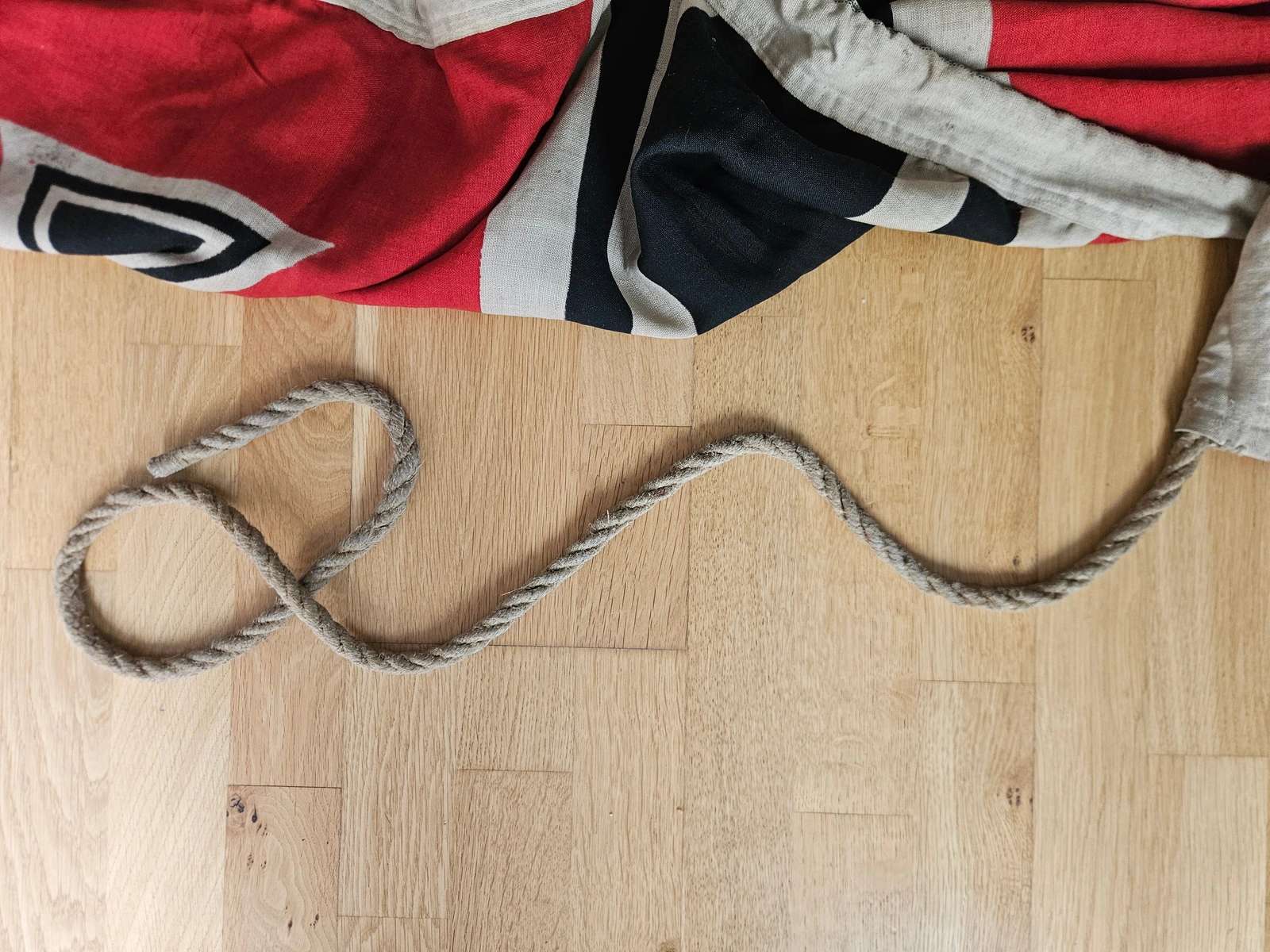 Thick rope attachment and stitching detail on lower hoist edge