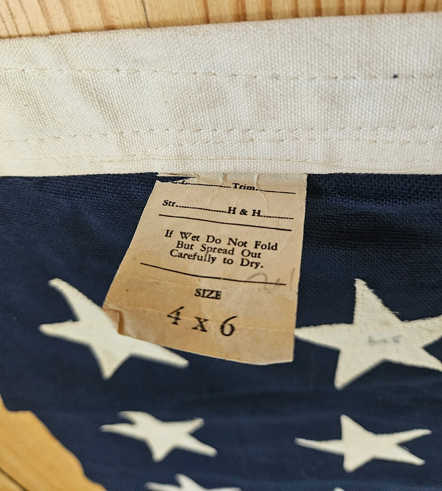 Original paper care label with drying instructions. Indicates unused or mint condition.