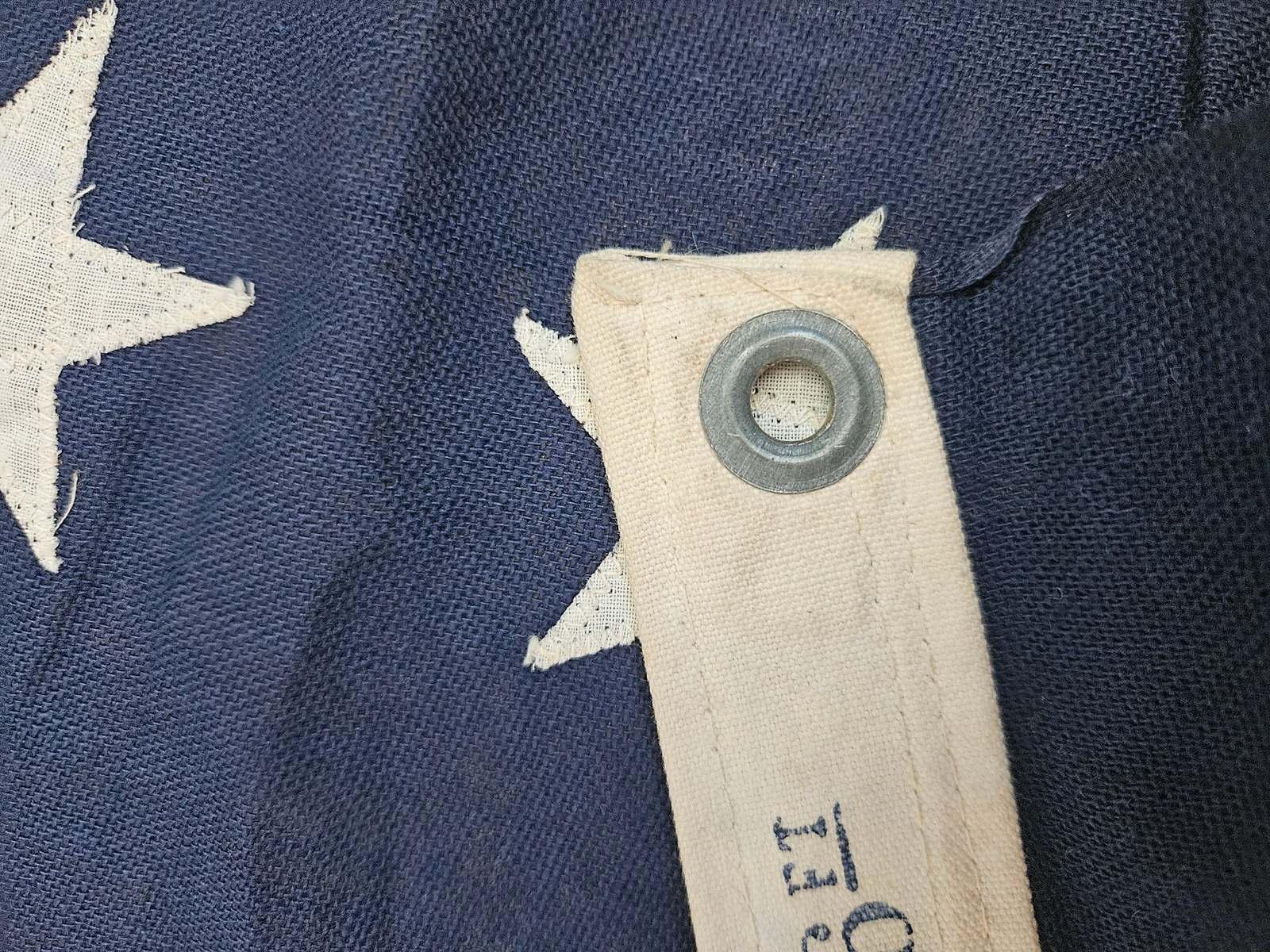 Detail view of WWII-era steel grommet in cotton duck header.